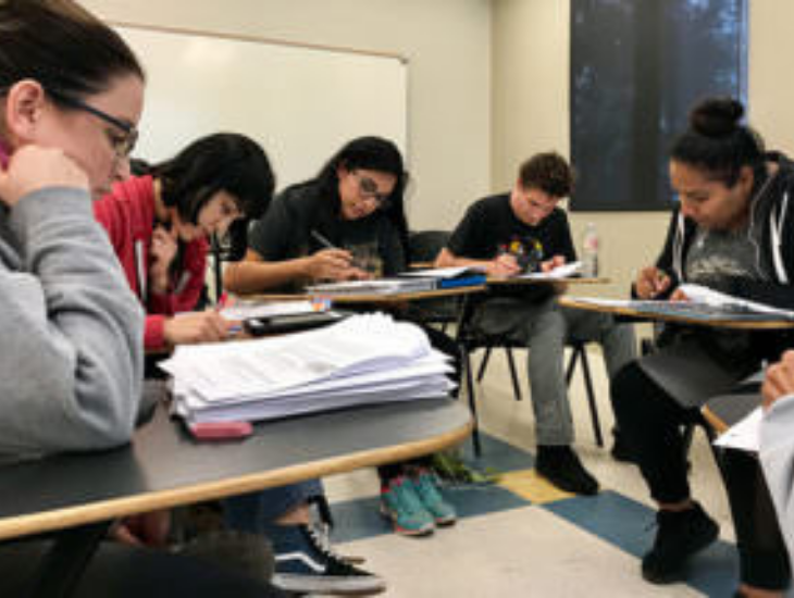 a group of students working together in class